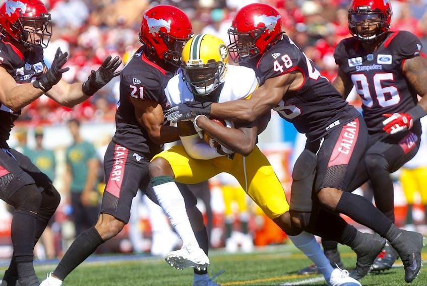 The Calgary Stampeders defence stops DaVaris Daniels of the Edmonton Eskimos in the Labour Day Classic in Calgary on Sept. 2, 2019. 
