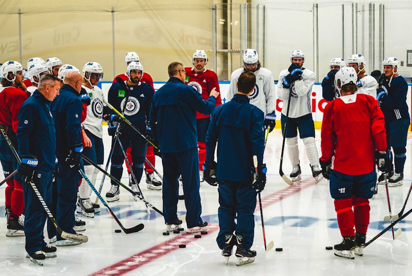 Winnipeg Jets coach Paul Maurice, centre, talks to his team at the Downtown Community Arena in Edmonton on Monday, July 27, 2019. 