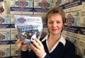 ["Esther Dockendorff, president of P.E.I. Mussel King and vice-president of its subsidiary, P.E.I. Mussel Farms, shows the companies' new product, Mussels in Minutes. The mussels come in a microwavable bag with veggies and seasonings to make a meal ready in three minutes."]
