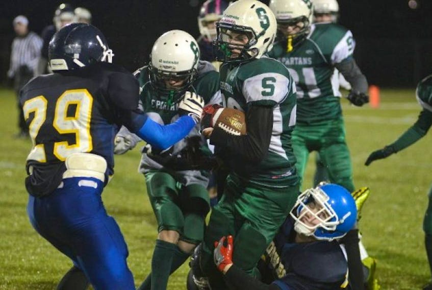 <p>Summerside Waterwise Spartans running back Ethan Lawless is tackled by Cornwall Timberwolves Colin Walsh Friday during the Ed Hilton Bowl at UPEI.</p>