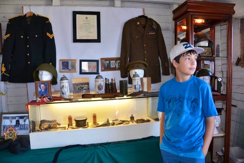 Eleven-year-old Sackville resident Ethan Doherty is shown with some of his military collection, recently on display at the Doncaster Farm during the Sackville Fall Fair. KATIE TOWER – SACKVILLE TRIBUNE-POST