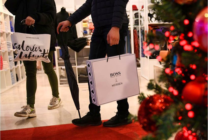 FILE PHOTO: People walk past Christmas decoration in a department store ahead of the Christmas celebrations in Berlin, Germany December 23, 2019.  REUTERS/Annegret Hilse/File Photo