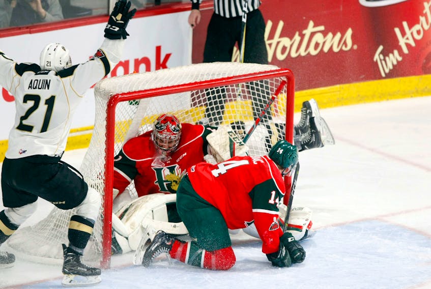 Charlottetown Islanders forward Pascal Aquin, left, celebrates after teammate Keith Getson scores a shorthanded goal midway through the second period. After the play was reviewed by video goal judge, they ruled the puck was pushed in net by the sliding Halifax defenceman Jared McIsaac who ran into goaltender Alexis Gravel.