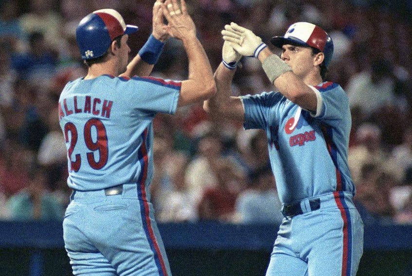  Expos’ Larry Walker is greeted by teammate Tim Wallach, left, after Walker’s two-run home run in 1990.