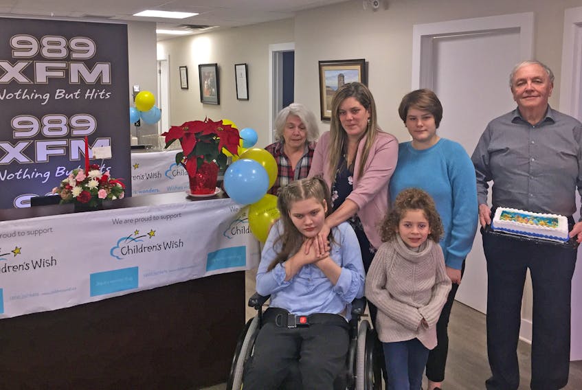 Faith Swinkels-MacLean and her family are heading to Walt Disney World in Florida, courtesy of the Children’s Wish Foundation. Antigonish foundation representative Gary Cusack, right, made the presentation to Faith, her mother Jillian, sisters Dakota and Quinn, and grandmother Pam MacLean on Christmas Eve at 989 XFM in Antigonish. Corey LeBlanc