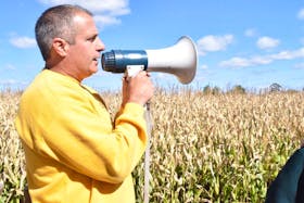 <span class="Normal">RiverBreeze Farm and Cornmaze owner Jim Lorraine talks over the megaphone to customers taking a trailer ride out to the pumpkin u-pick. Joke after corny joke, Lorraine talked about his pumpkin patches, as well as the type of corn used in the annual corn maze.</span>
