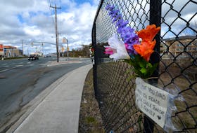 Flowers have been attached to the fence next to the scene of the multi-vehicle crash on Topsail Road that killed two men Monday night. 

Keith Gosse/The Telegram