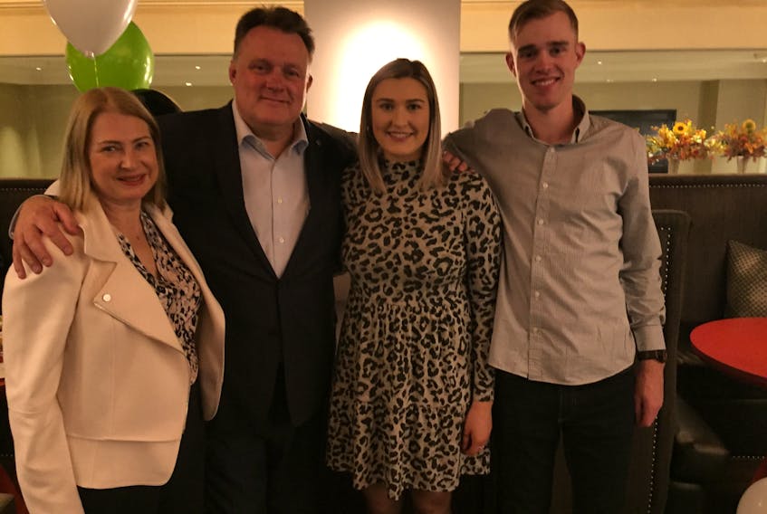 Mike Savage, returned as mayor of Halifax Regional Municipality for a third term Saturday, celebrates at the Halifax Marriott Harbourfront hotel restaurant with his wife Darlene, daughter Emma and son Conor.