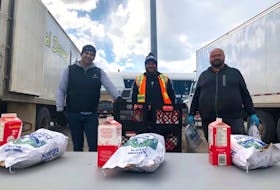 Dairy distributor Stephen Simms, left, and farmers Ian Richardson and Melvin Rideout teamed up to give away potatoes and milk at the Hodder Memorial Centre in Deer Lake on Friday.
Contributed