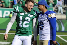 Winnipeg Blue Bombers kicker Justin Medlock, right, congratulates Brett Lauther after the Roughriders' kicker made a game-winning field goal in the Labour Day Classic on Sept. 1. 