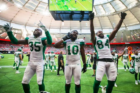 Saskatchewan Roughriders players, left to right, Dyshawn Davis, Solomon Elimimian and Manny Arceneaux celebrate on Saturday against the B.C. Lions, who fell 45-18 at BC Place. Davis, Elimimian and Arceneaux are all ex-Lions.
