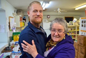 Twelve Baskets Food Bank manager Joan Morrison gave Nick Selig a big hug after he presented the food bank with a cheque for $1,000 he raised on GoFundMe. Somebody broke into the food bank overnight Dec. 16, 2019 and made off with food meant for hungry families. LAWRENCE POWELL (file)