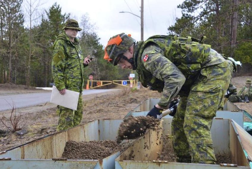Private Kyle Ryan of The Cape Breton Highlanders is timed as he completes the simulated trench dig at Camp Aldershot during the competition.