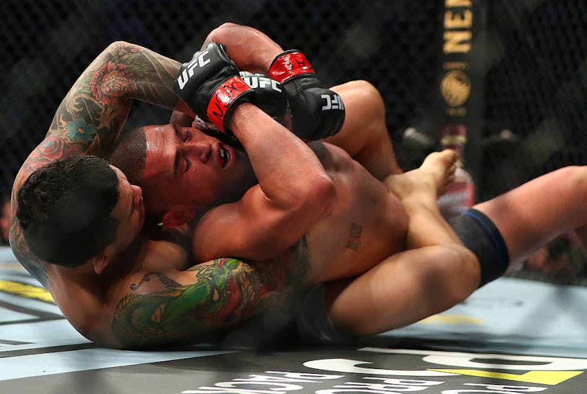 Diego Ferreira applies a hold against Anthony Pettis during UFC 246 at T-Mobile Arena in Las Vegas on Saturday, Jan. 18, 2020.