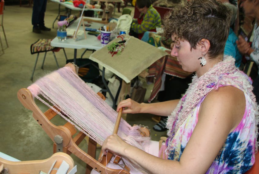 Claire Drinnan, of Baddeck, was doing some weaving with mohair at the Fibre Frolic. Several fibre artists were providing demonstrations.