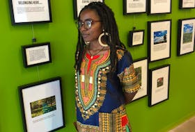 Praise Mugisho in front of the exhibit called Picturing Recreation at the Halifax Central Library on Wednesday, Sept. 25, 2019. Mugisho is one of the newcomers who submitted photos that show personal definitions of recreation.