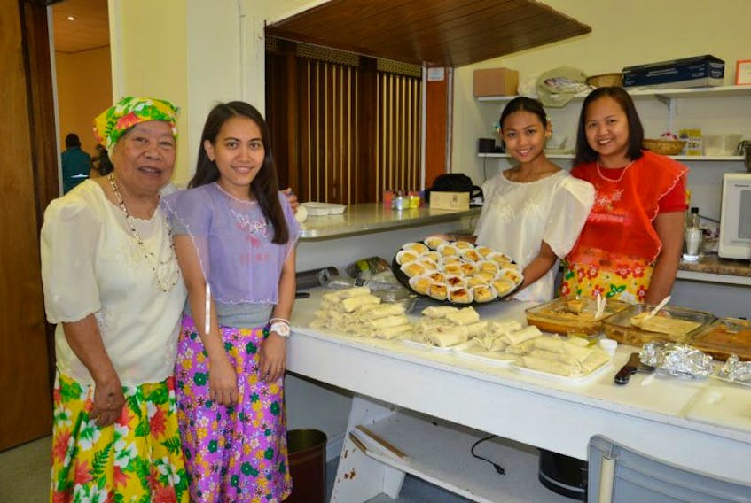 Several members of the local Filipino community helped out in the kitchen during a lunch featuring Filipino food Thursday in Whitney Pier. From left were Juanita Rolls, Karen Ann Olat, and Venus Sorizo and her mom Mia Gorman.