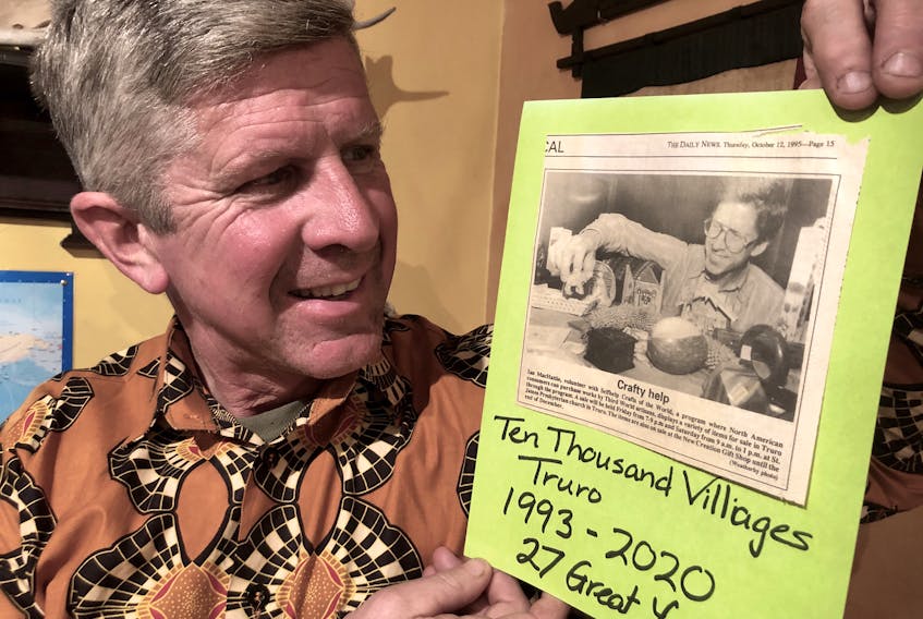 Ian MacHattie looks at a photo of himself volunteering with a Ten Thousand Villages fair in 1995. The final Nova Scotia sale for the Fair Trade crafts will take place in Truro, April 3 and 4. CONTRIBUTED