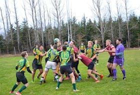 The host Three Oaks Axemen, striped jerseys, and Colonel Gray Colonels battle in the championship game of the 23rd annual David Voye Memorial rugby tournament. The Axemen won the final, played at the Canada Games pitch on the campus of Three Oaks Senior High School in Summerside, by a 28-0 score.