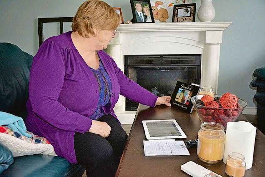 <p>Vicki Henwood keeps a picture of her grandchildren close as she watches news from the Fort McMurray fires in Alberta. Henwood, of Summerside, has a daughter, son-in-law, and two grandsons stuck at an oilsands work camp north of the city and is working to get them back to the Maritimes.</p>
<p>&nbsp;</p>