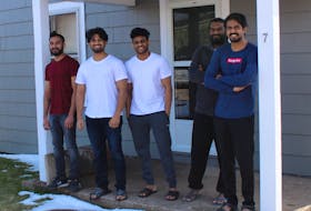 From left, Alwin Biju Kuriakose, Sarin Sasidharan, Rahul Radhakrishnan, Aswin Pariyaran and Ashif Abdul Azeez stand on the front step of the house they are renting in Sydney, which they moved into a week after a fire at 413 Charlotte Street in March lead to the demolition of their apartment building. Many of the men, who are from Kerala, India, and came to Nova Scotia to study at Cape Breton University, had recently been laid off from their jobs before the fire due to businesses closing or downsizing staff while the health protection orders are in place to stop the spread of COVID-19. NICOLE SULLIVAN/CAPE BRETON POST 