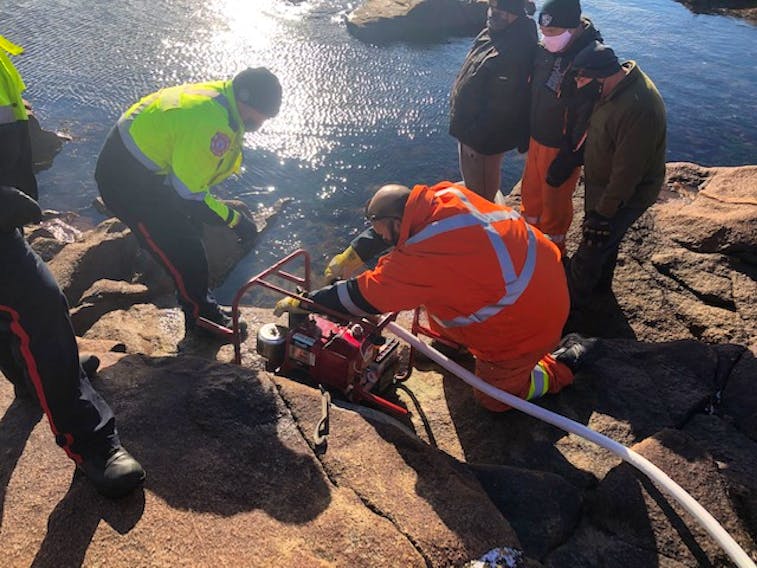 Black Tickle trainees getting hands-on experience learning how to use their new emergency fire pump. - Courtesy of Nalcor Energy