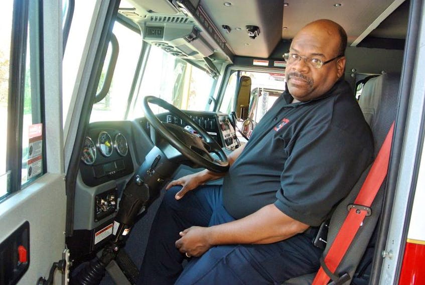 Chief Greg Jones sits behind the wheel of the Amherst Fire Department's new pumper truck.
