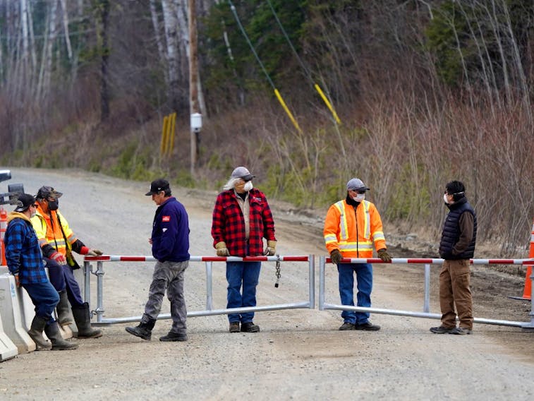 Residents, including Chief Wilfred King, far right, stand at a checkpoint restricting access to their community to slow the spread of coronavirus disease (COVID-19) in their remote First Nations community of Gull Bay, Ontario, Canada April 27, 2020.