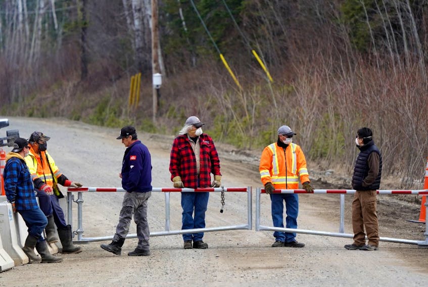 Residents, including Chief Wilfred King, far right, stand at a checkpoint restricting access to their community to slow the spread of coronavirus disease (COVID-19) in their remote First Nations community of Gull Bay, Ontario, Canada April 27, 2020.