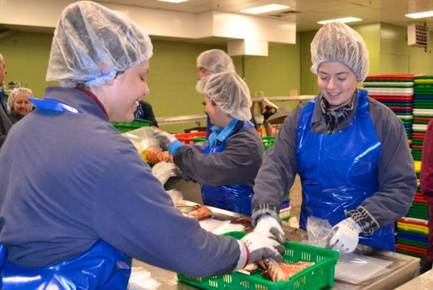 <p>Third-year university students Taylor Donald, left, and Megan Handrahan are in their second and third year respectively working at Royal Star Foods in Tignish. This year both students are eligible to receive a bursary bonus of $1,000 at the end of their employment.</p>