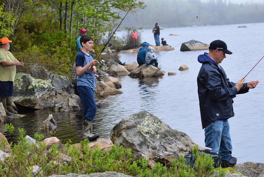 People enjoy fishing from the shore at Alvin Lake during last year's SCFGA fishing derby. Kathy Johnson