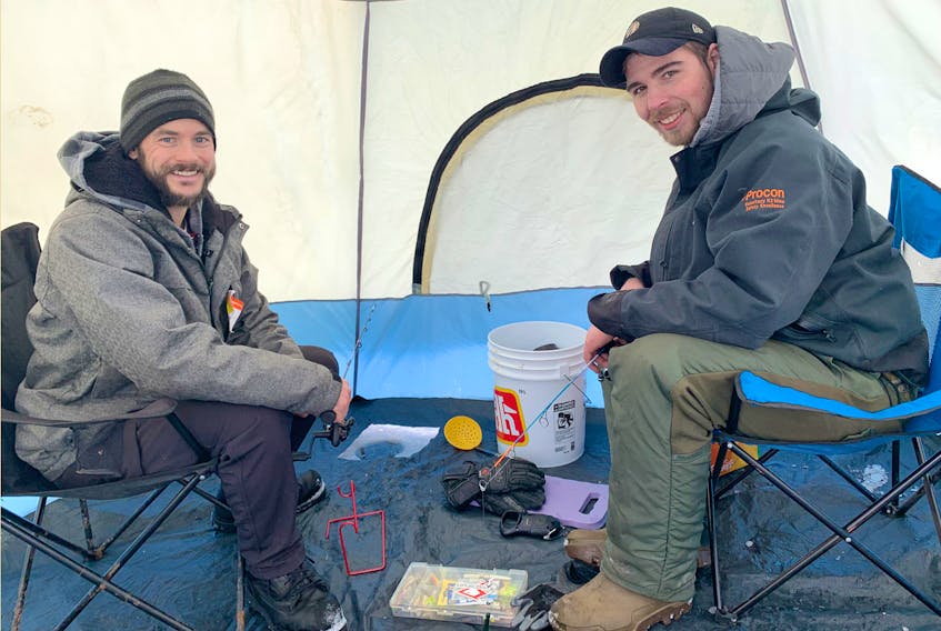 Friends and co-workers Matt Robinson, left, and Jordell Cameron enjoy getting outdoors and enjoying nature. The duo are avid fishermen, who this week went ice fishing on Shortts Lake, near Brookfield, for the first time.