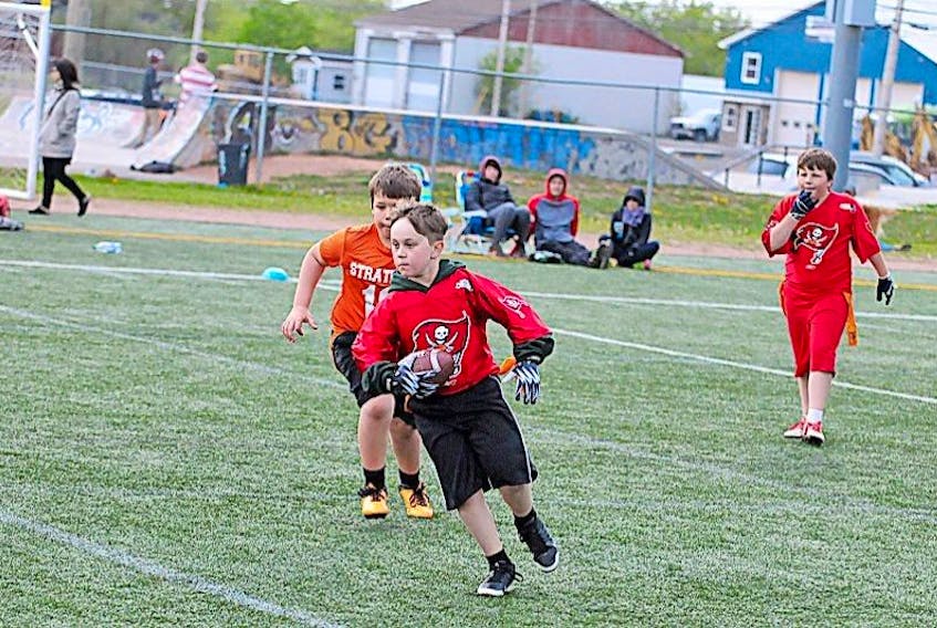 Landon Laughlin of the Summerside White Spartans’ under-11 team rushes the ball during round-robin play in the Summerside Spartans Bowl flag football tournament at Eric Johnston Field last year.
