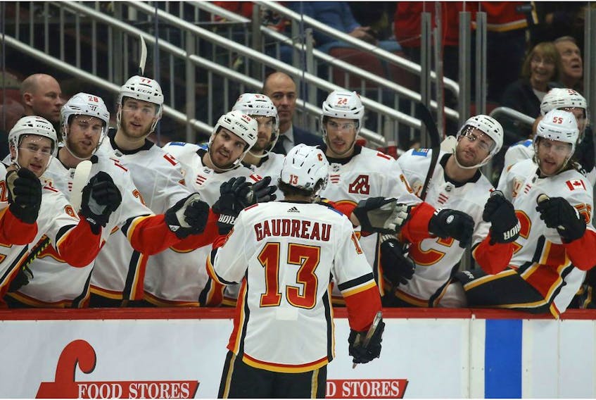 Calgary Flames left wing Johnny Gaudreau celebrates his goal against the Arizona Coyotes during the first period of an NHL hockey game Tuesday in Glendale, Ariz.