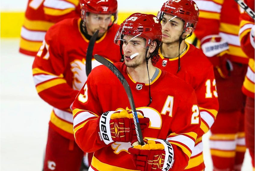 Calgary Flames Austin Czarnik, Sean Monahan and Johnny Gaudreau after losing game five of the Western Conference First Round during the 2019 NHL Stanley Cup Playoffs at the Scotiabank Saddledome in Calgary on Friday, April 19, 2019. Al Charest/Postmedia
