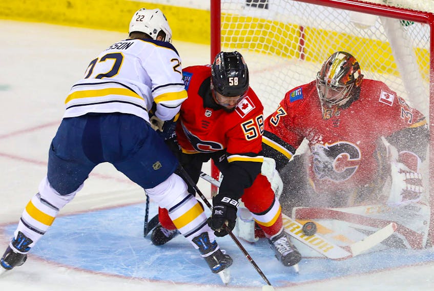 Calgary Flames goalie David Rittich makes a save on Buffalo Sabres' Johan Larsson at the Saddledome on Wednesday, Jan. 16, 2019. 