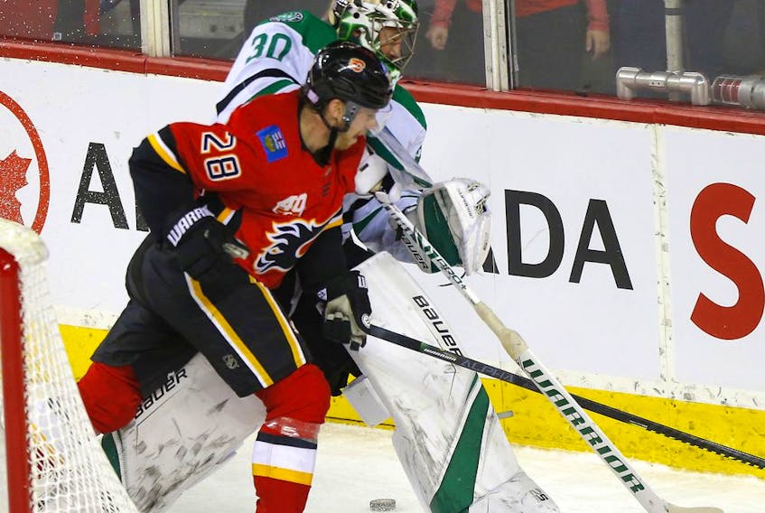 The Calgary Flames’ Elias Lindholm battles Dallas Stars goalie Ben Bishop at the Scotiabank Saddledome in Calgary on Nov. 13, 2019. Darren Makowichuk/Postmedia
