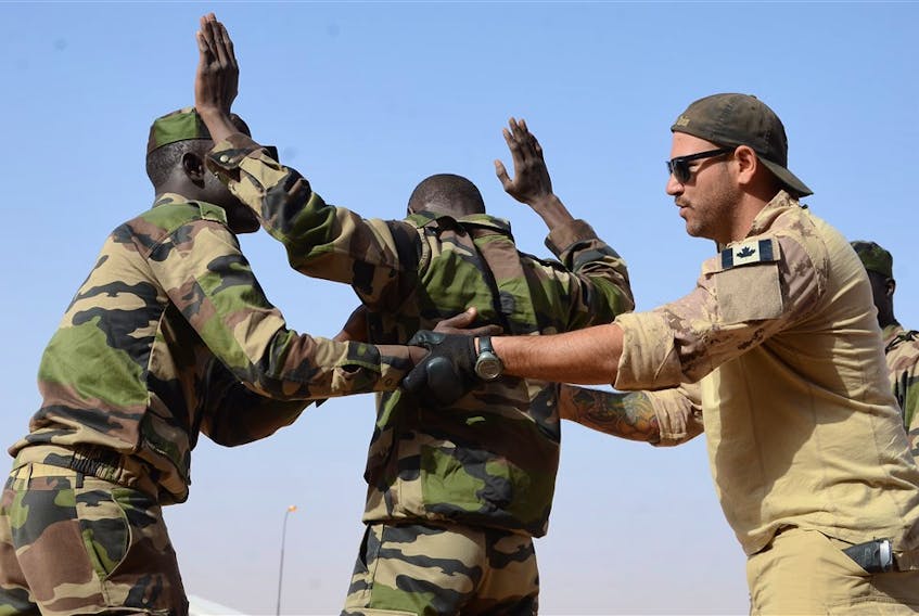 A Canadian Special Operations Regiment instructor teaches soldiers from the Niger Army how to properly search a detainee in Agadez, Niger, Feb. 24, 2014 during that year’s Flintlock exercise. (U.S. Army photo)