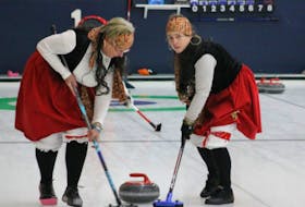 Clad in pirate costumes, Ginny Schultz, left, and Frances MacKinnon of the Glooscap Curling Club sweep the ice during Flirts In Skirts.