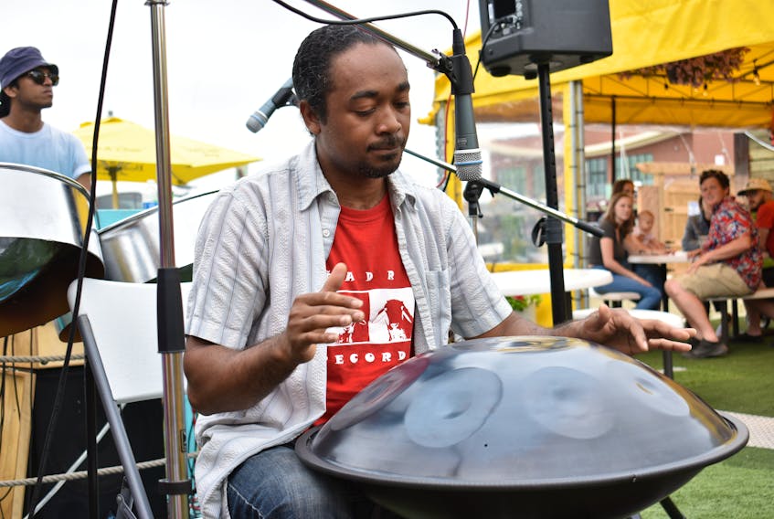 Steelpan musician Pepeto Pinto plays one of his drums and was the second act of the day at the Peake's Quay floating dock on Canada Day.