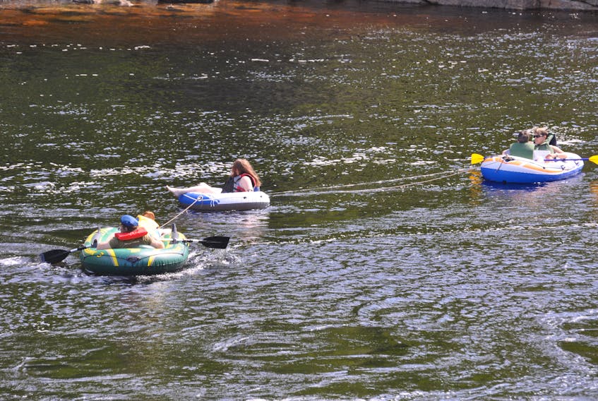 With the temperature already above 20 C by midmorning on Wednesday, July 22, and the sun out it was the perfect day for a float down the Humber River. This group of vacationers from Nova Scotia were spotted in their inflatable boats and float working their way through some little rapids just past Shellbird Island headed towards Riverside Drive.