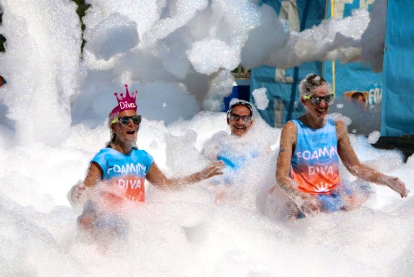 Foam-coated runners were full of smiles as they entered the starting gate for Foam Fest at Ski Wentworth on Saturday. About 3,500 people took part in the 5K event, which included several fun obstacles.