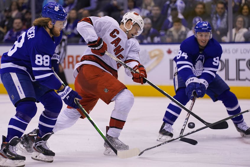 Carolina Hurricanes forward Warren Foegele shoots the puck as Toronto Maple Leafs forward William Nylander (left) and defenceman Tyson Barrie defend during the second period at Scotiabank Arena on Saturday. (John E. Sokolowski/USA TODAY Sports)