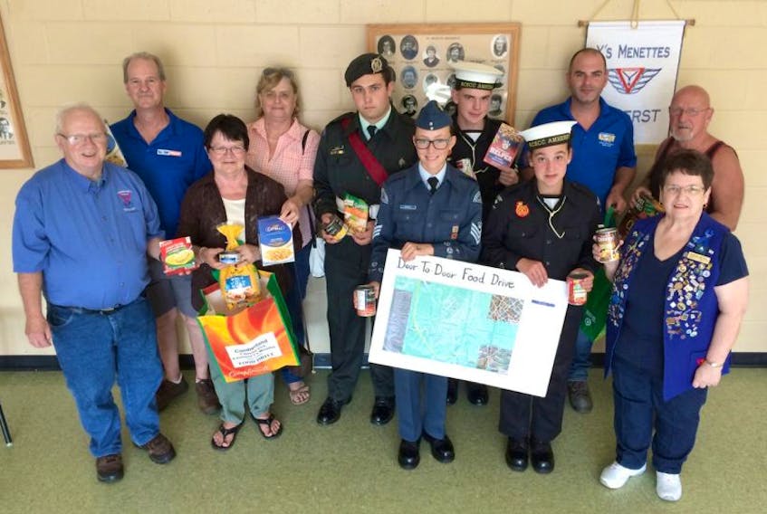 Several organizations are volunteering to help collect food for Saturday’s food drive, including the members of the United Steel Workers, and members of the Air, Army and Sea Cadets. Volunteers holding up examples of non-perishable food items are: (front, from left) Carmen Merrill, Maryanne Wagge, Autumn Grindley, Samantha Aylward, Sharon Merrill, (back, from left) Earl Dow, Del LeBlanc, Johnathan Murray, Sebastian Dimichele, Richard Allen, Lorne Clark. Volunteers not in photo include the Amherst Ramblers hockey team and Cubs and 
Scouts.
