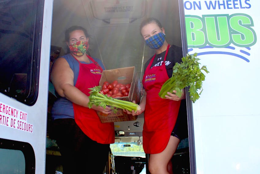 Emma Jerrott, left, and Siobhan Schreinert from the Good Food Bus were at the Whitney Pier Youth Club in Sydney on Wednesday afternoon. The New Dawn Enterprises-led mobile market delivers fresh, affordable food to communities throughout the Cape Breton Regional Municipality in a retrofitted Handi-Trans bus. The bus will be in New Waterford today from 4-5:30 p.m. at the Knights of Columbus before travelling to Community CARES in Sydney Mines from 10:30 a.m.-12 p.m. and Heritage Park in Membertou from 1:30-3 p.m. on Saturday. The bus will return to New Waterford from 4-5:30 p.m. on Aug. 27 before heading to Warden United Church in Glace Bay from 10-11:30 a.m. and the Polish Village Hall in Whitney Pier from 1-2:30 p.m. on Aug. 29. Chris Connors • Cape Breton Post