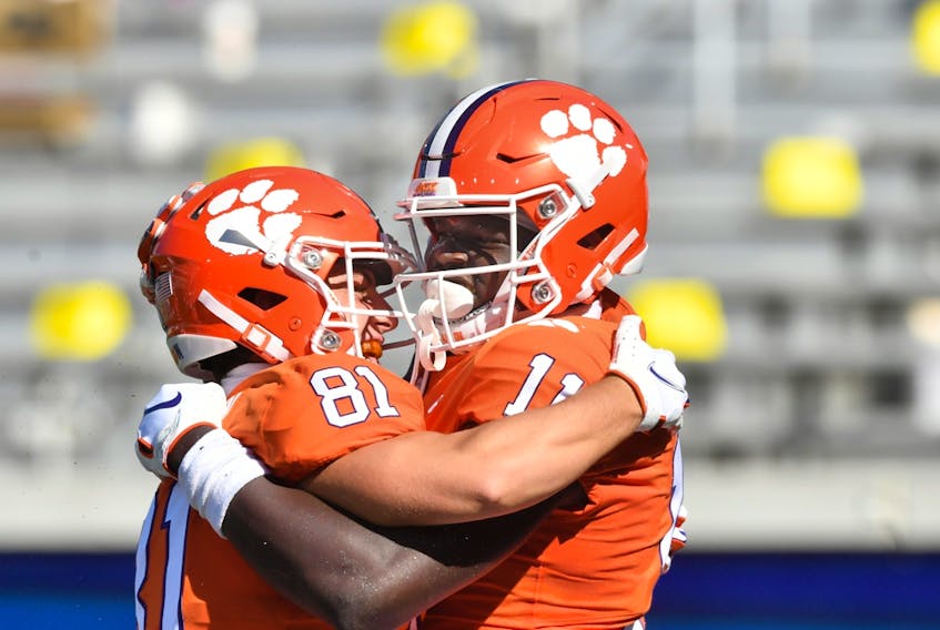 Harry Ainlay Titans high-school product Ajou Ajou (11) celebrates with fellow Clemson Tigers wide receiver Drew Swinney (81) after scoring his first NCAA touchdown against the Georgia Tech Yellow Jackets at Bobby Dodd Stadium, on Saturday, Oct. 17, 2020.