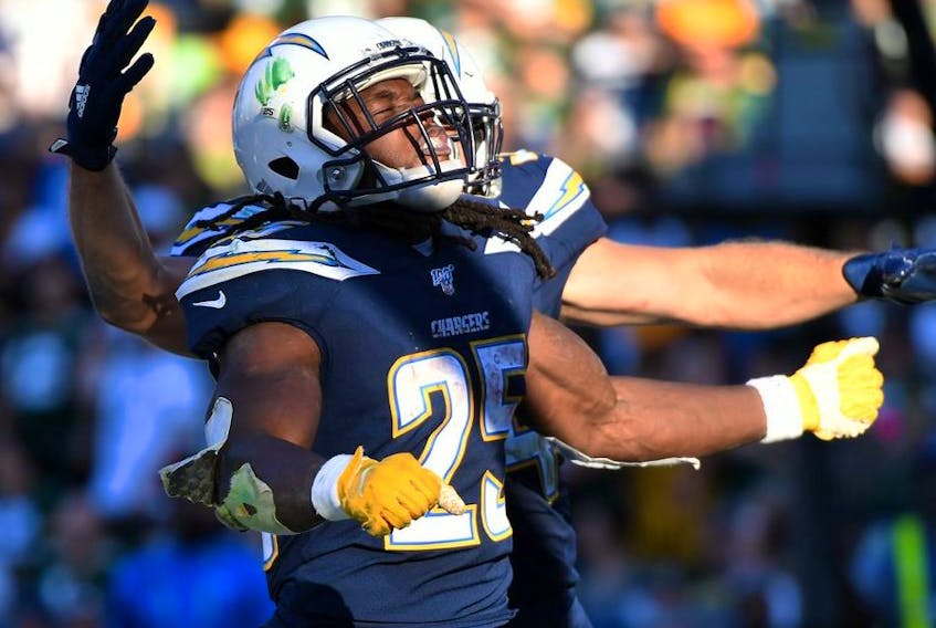 Los Angeles Chargers running back Melvin Gordon celebrates with fullback Derek Watt after scoring on a one yard touchdown run against the Green Bay Packers during the fourth quarter at Dignity Health Sports Park. 