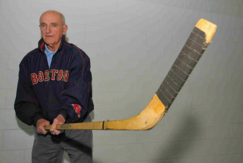 Forbes Kennedy displays a hockey stick he gave a fan in the early 1960s that was recently returned to him by the fan from Chicago.