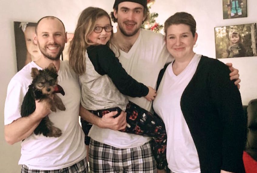 Former Cape Breton Eagle Egor Sokolov, middle, is shown with the Ryan family of Sydney on Wednesday evening. Sokolov, who had planned to stay in Cape Breton with his billet family for Christmas, was forced to leave for Ottawa Senators training camp on Thursday. The family held a special Christmas evening together Wednesday instead. From left, Kyle Ryan, Neico Ryan, Sokolov and Ashley Ryan. PHOTO SUBMITTED/ASHLEY RYAN