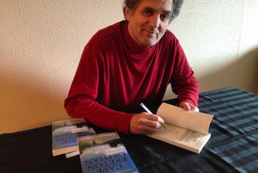 Randall Thompson, who writes under the name Randall James, signs copies of his latest book, “Cape Breton Orphan." CONTRIBUTED
